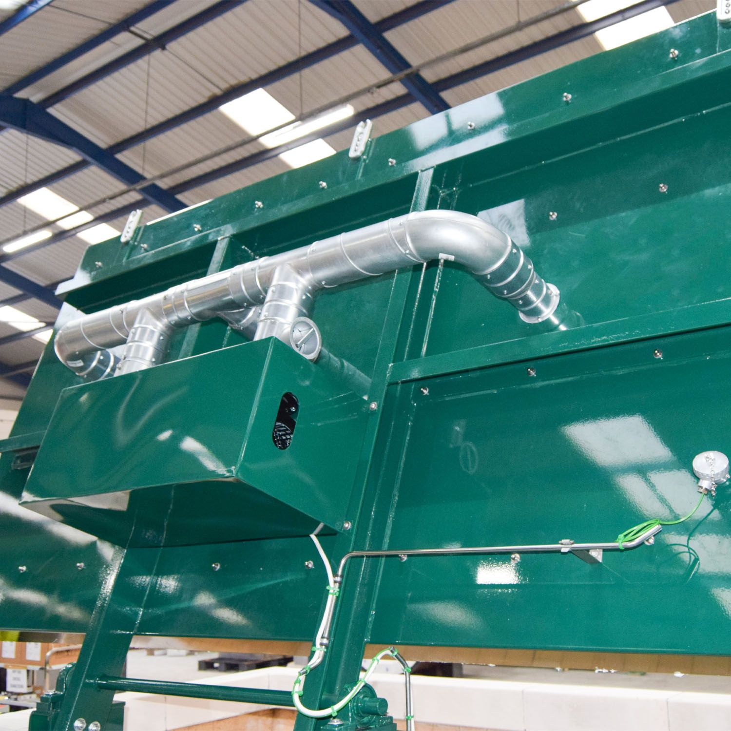 Combustion air ducting along the top of the machine, feeding the fans that distribute air to each chamber.